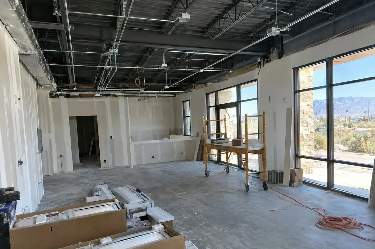 New conduit runs in the open ceiling of a commercial space during build-out